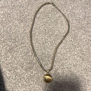 Gold tone necklace with greenish stone